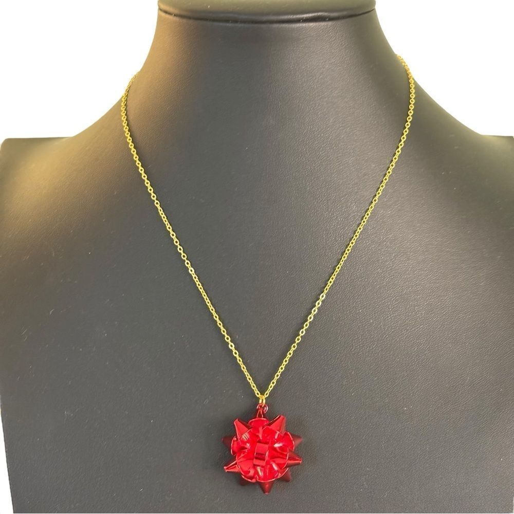 Festive Red Bow Pendant Necklace on Yellow Gold Toned Chain.